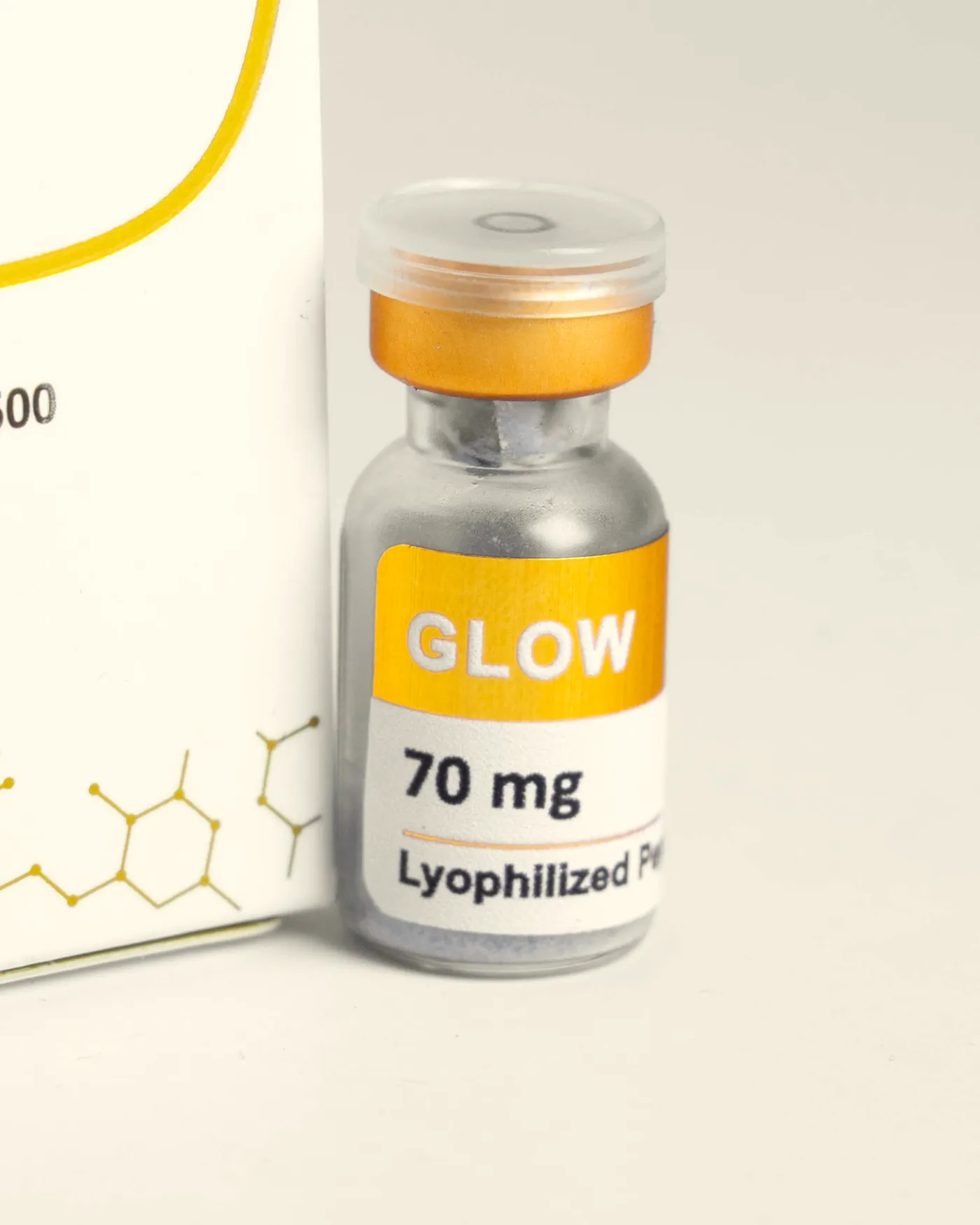 Vial de Glow Gold delante de su caja