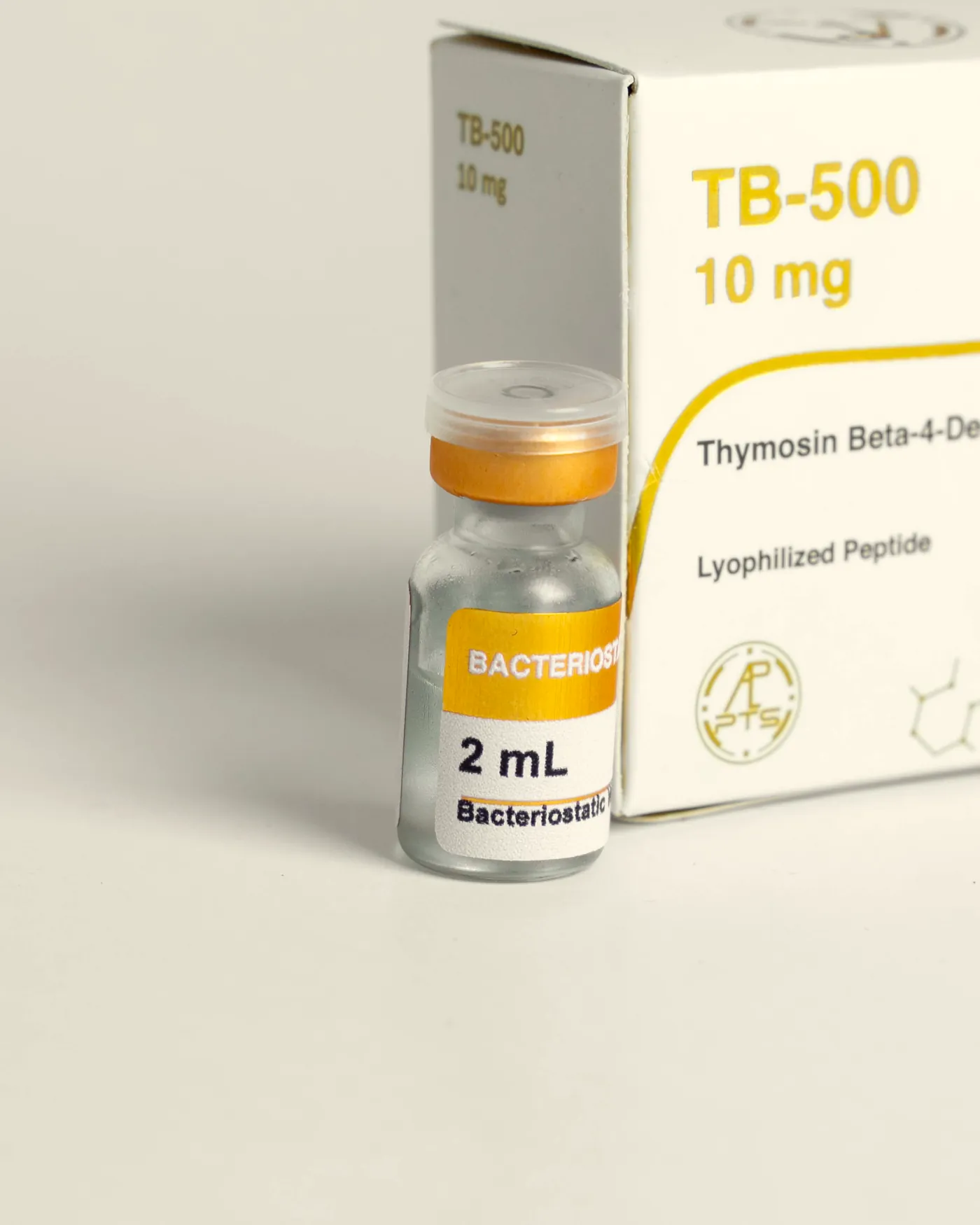 Vial de la Línea Gold delante de su caja